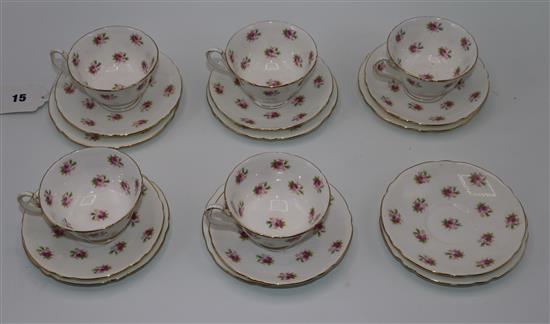 A china tea set with pattern of roses six tea plates, six saucers and five cups